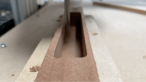 Animation of a CNC mill boring into mahogany